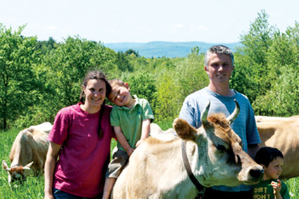 Katia and Brendan Holmes and their two sons tend their organic Jersey cows. 
